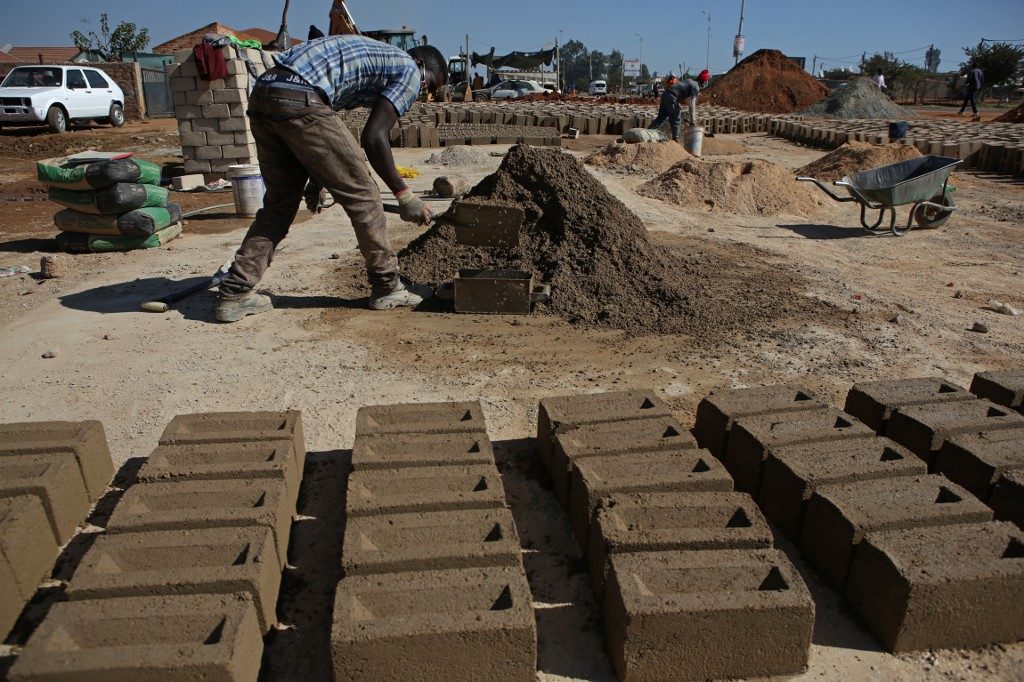 LABOR. A worker makes bricks on the side of the road at the Mamelodi township in Pretoria, South Africa, on June 1, 2020. Photo by Phill Magakoe/AFP  