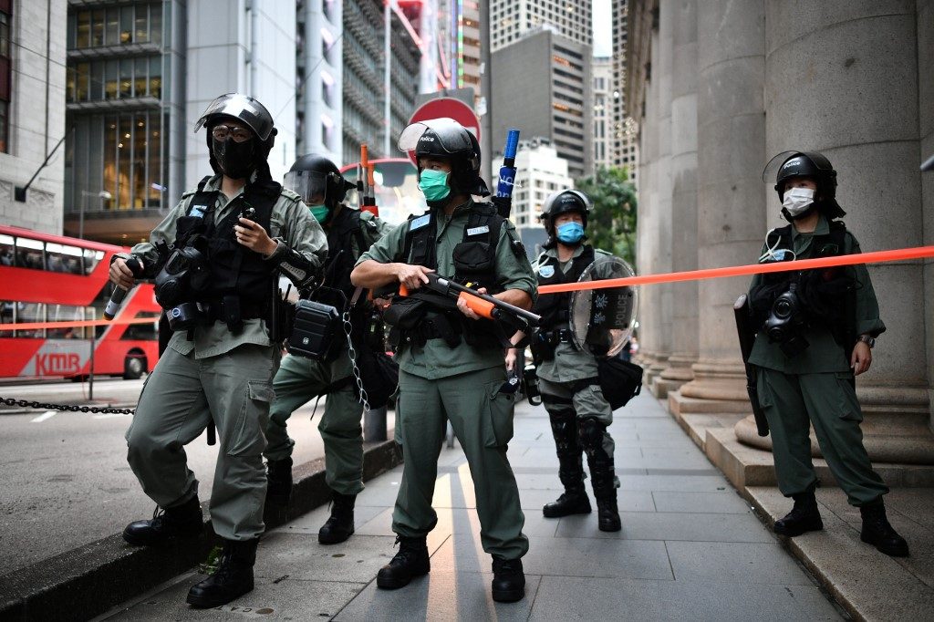 RIOT. Riot police officers stand guard ahead of a pro-democracy march in the Central district of Hong Kong on June 9, 2020. Photo by Anthony Wallace/AFP 
