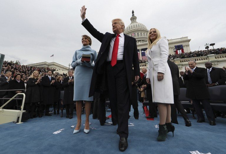 MR. PRESIDENT. US President Donald Trump acknowledges the audience after taking the oath of office as his wife Melania (L) and daughter Tiffany watch during inauguration ceremonies swearing in Trump as the 45th president of the United States on the West front of the US Capitol in Washington, DC, January 20, 2017. Jim Bourg/Pool/AFP 