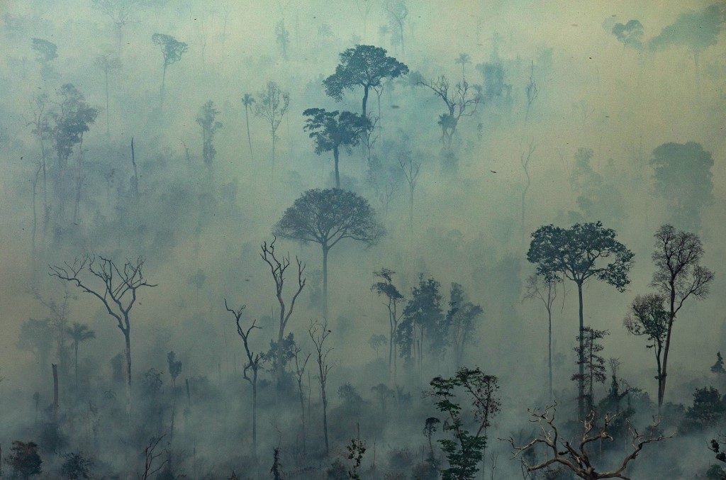 DEVASTATION. Handout aerial picture released by Greenpeace showing smoke billowing from fires in the forest in the Amazon biome in the municipality of Altamira, Para State, Brazil, on August 23, 2019. Photo by Victor Moriyama/Greenpeace/ AFP
 