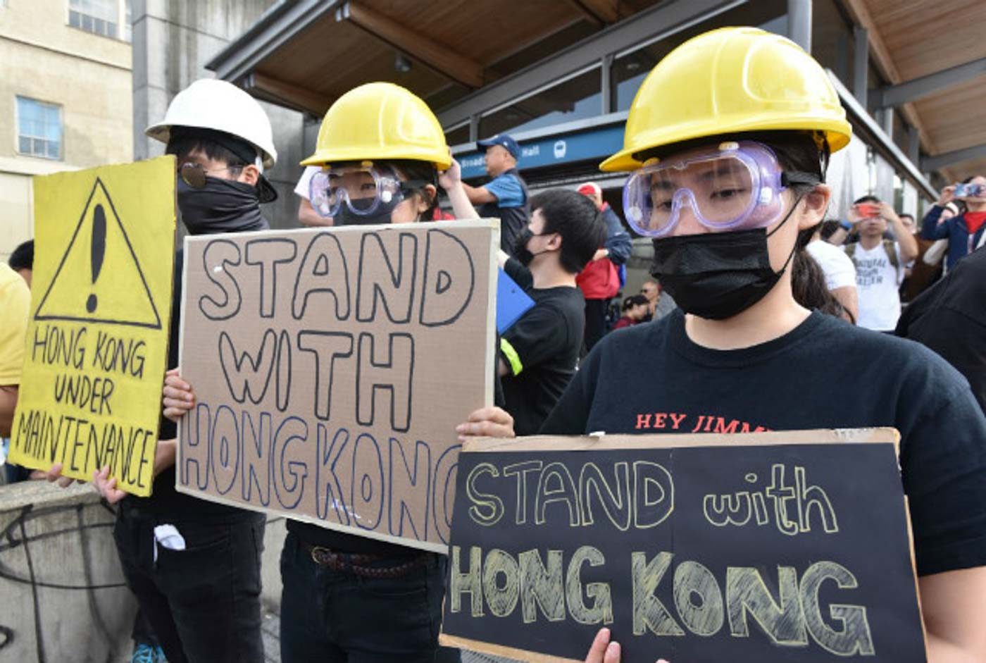 STAND WITH HONG KONG. Pro-Hong Kong supporters hold signs during a rally at the Broadway-City Hall SkyTrain Station in Vancouver, Canada on August 17, 2019. Photo by Don MacKinnon/AFP 