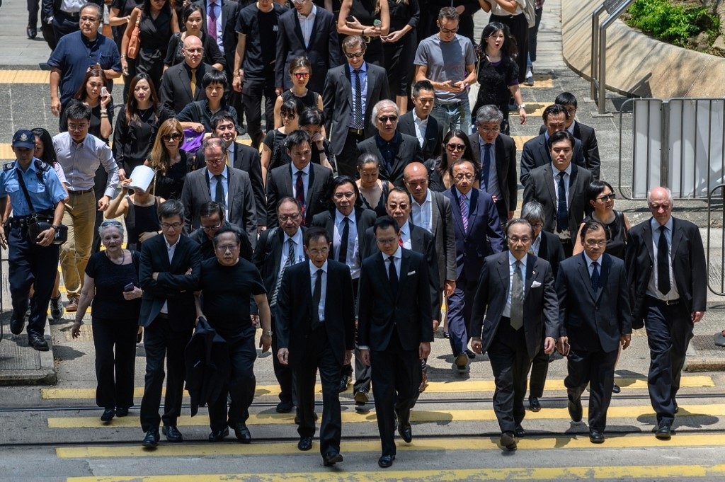 Hong Kong lawyers march in silence to support democracy protesters