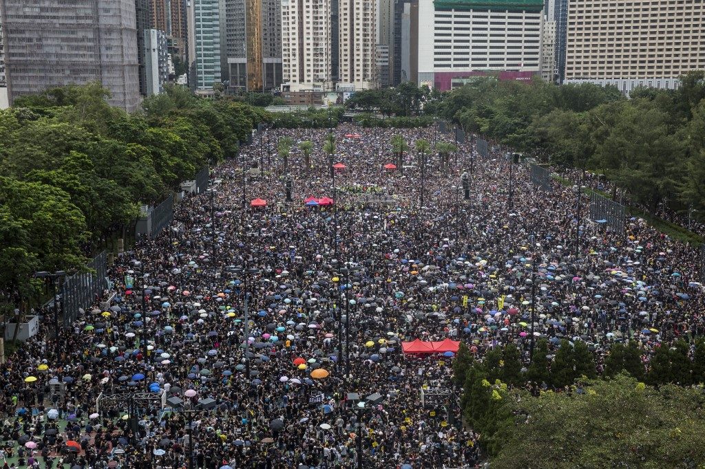 Hong Kong protesters flood city streets in largest rally in weeks