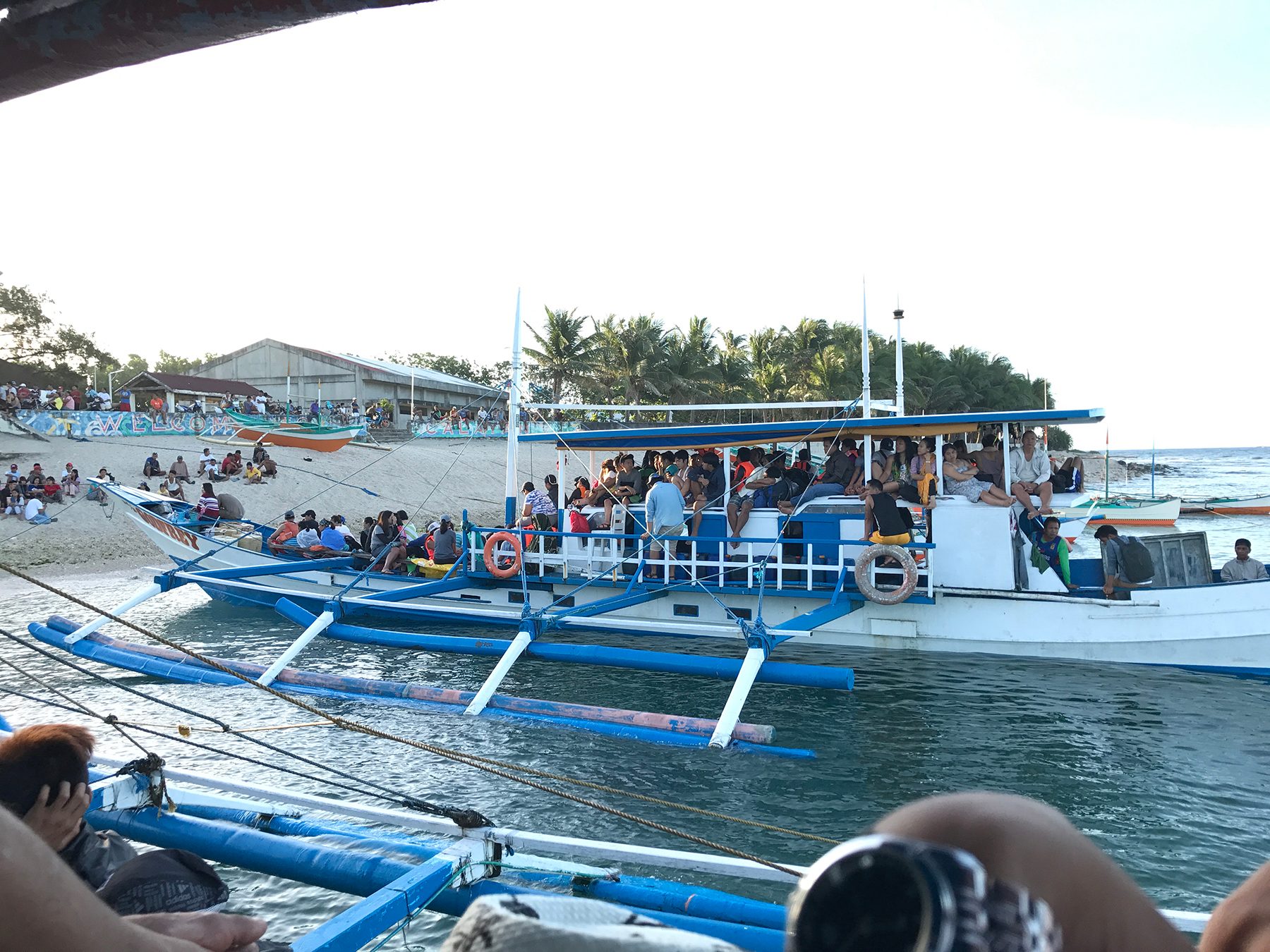 LOCAL BOAT. Tourists ride an outrigger boat, locally known as lampitaw. Photo by Raymon Dullana/Rappler  