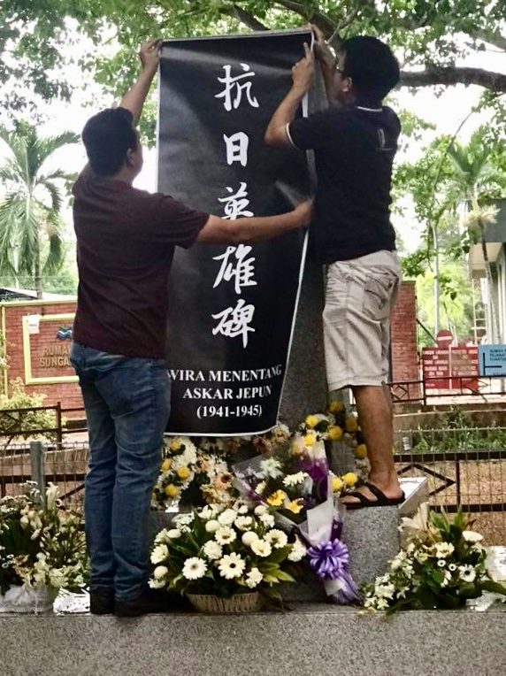 PROTEST. MCA members had drape black cloth over the monument covered with the words: 'Heroes monument for those who fought Japan.' Photo from MCA National Youth Facebook  