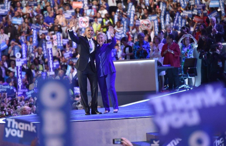 TOGETHER. US President Barack Obama (L) waves with US Presidential nominee Hillary Clinton during the third night of the Democratic National Convention at the Wells Fargo Center in Philadelphia, Pennsylvania, July 27, 2016. Nicholas Kamm/AFP 