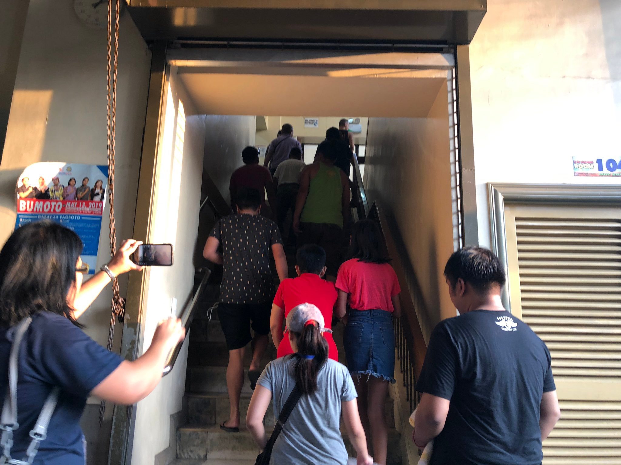 MAKATI. The first batch of voters enters the San Antonio National High School in Makati as the polling precinct opens. Photo by Mara Cepeda/Rappler   