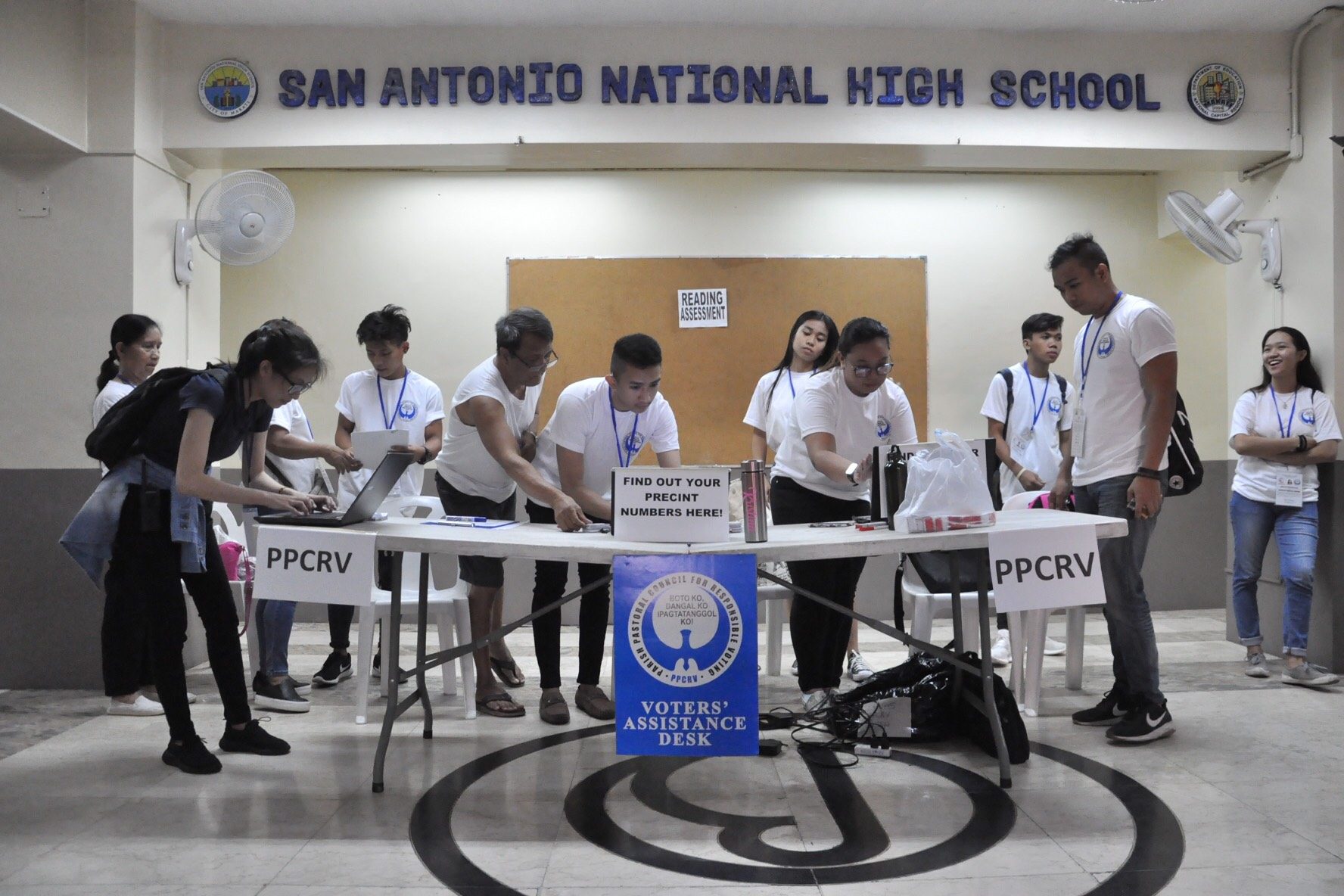 WATCHDOG. Parish Pastoral Council for Responsible Voting volunteers prepare their Voters Assistance Desk at San Antonio National High School in Makati City. Photo by Jay Ganzon/Rappler
    