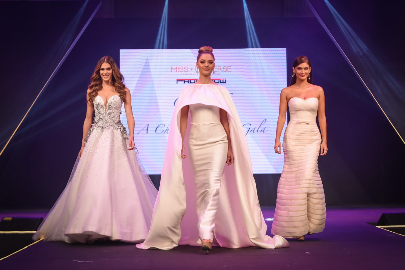 Iris, Demi-Leigh, and Pia walk together onstage 