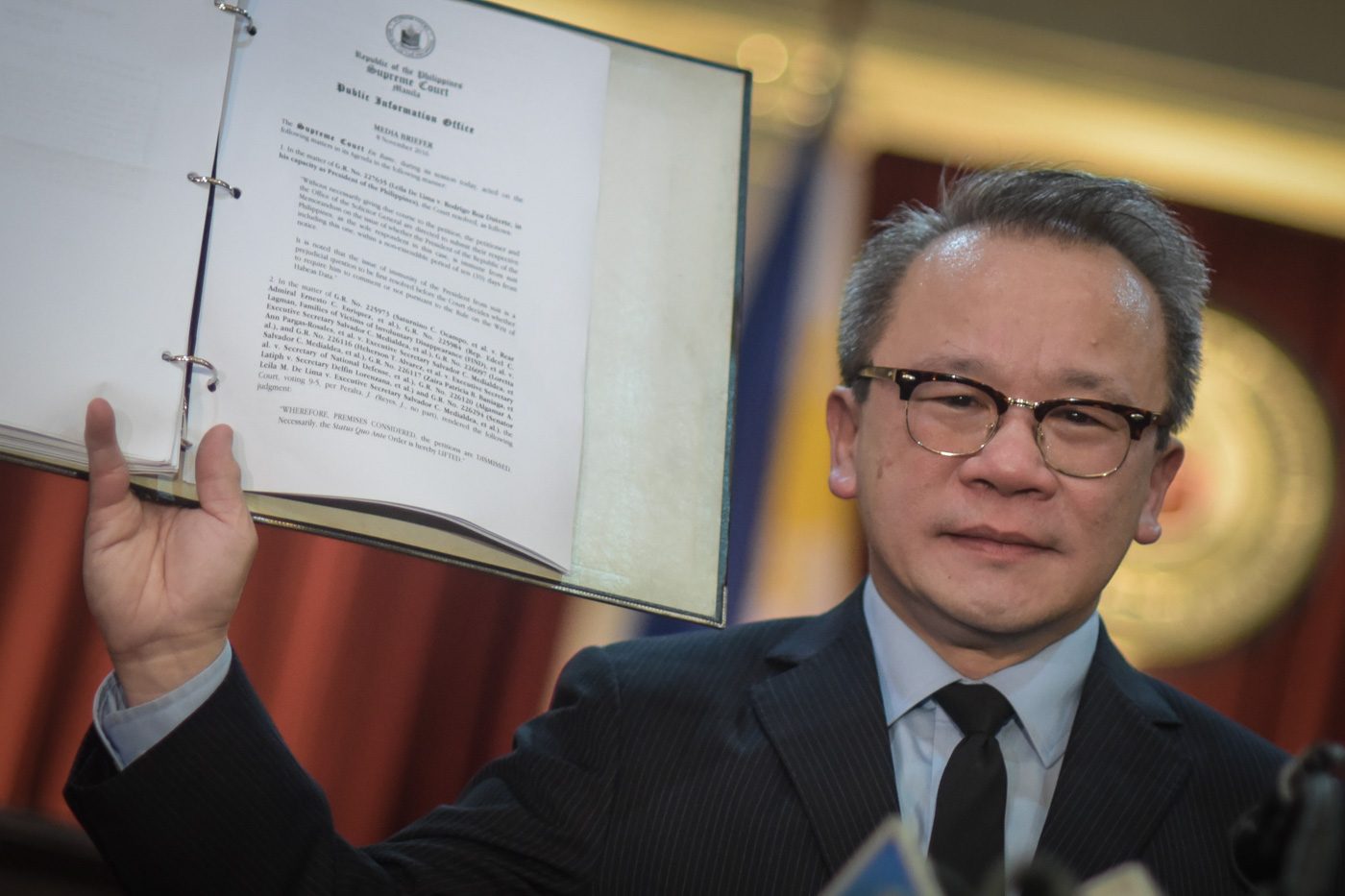 VERDICT. SC spokesperson Theodore Te holds up the decision before media during a press conference on November 8. Photo by LeAnne Jazul/Rappler 