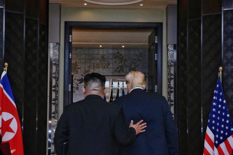 HISTORIC. US President Donald Trump (R) and North Korea's leader Kim Jong Un (L) leaves the the Capella Hotel conference room after a signing ceremony during their historic US-North Korea summit on Sentosa island in Singapore on June 12, 2018. Photo by Kevin Lim/The Straits Times/AFP  