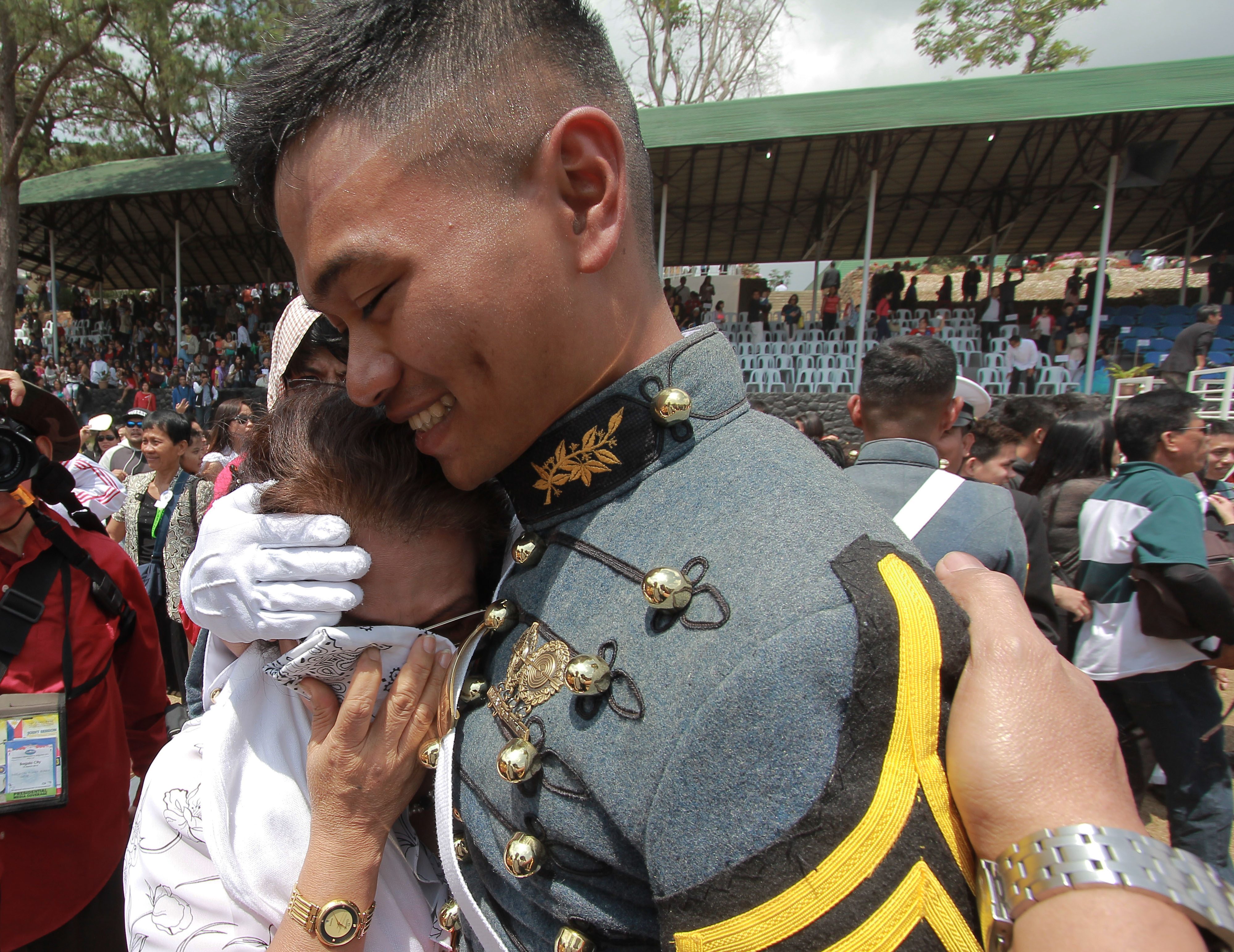 EMOTIONAL RITES. Mother of Cadet first class Miguel Victor Dajo gets sentimental after the PMA "Sinaglahi' class 2015 graduation rites. 