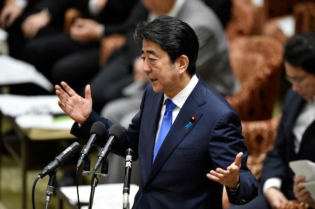 Public support plunges for Japan PM Abe over defense bills
