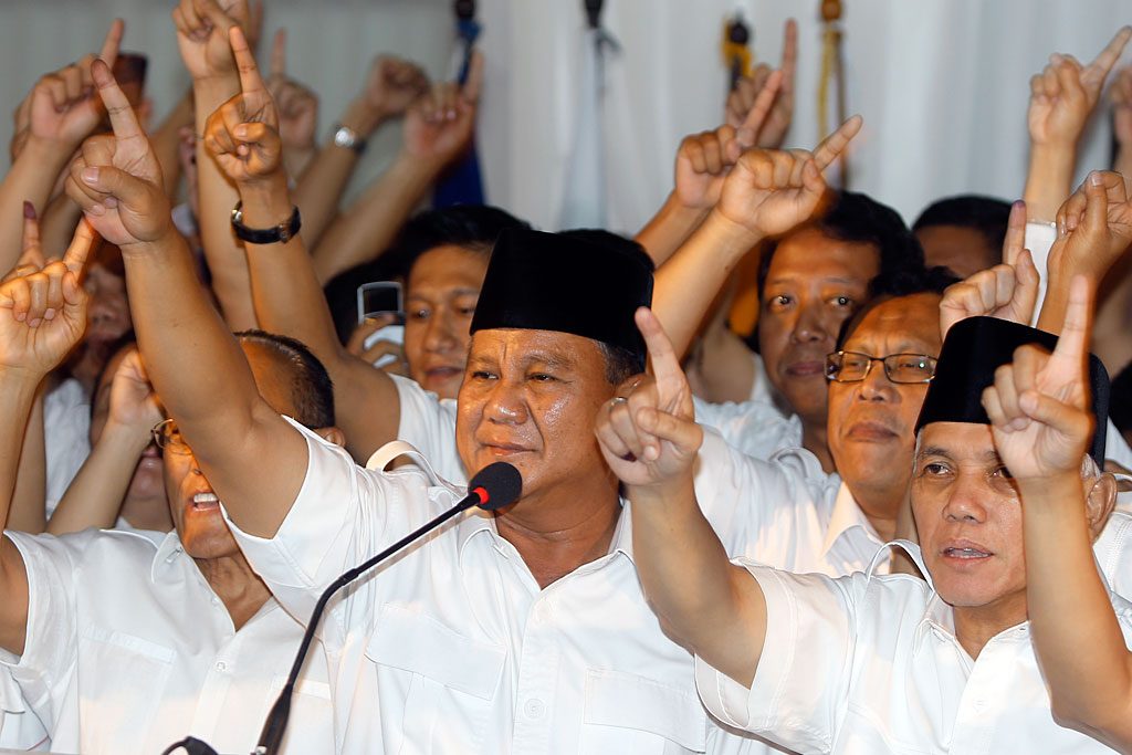 Great Indonesia Movement party candidate Prabowo Subianto and running mate Hatta Rajasa (R) raise their fingers as they celebrate their winning based on their quick counts during a press conference in Jakarta. Photo by Adi Weda/EPA