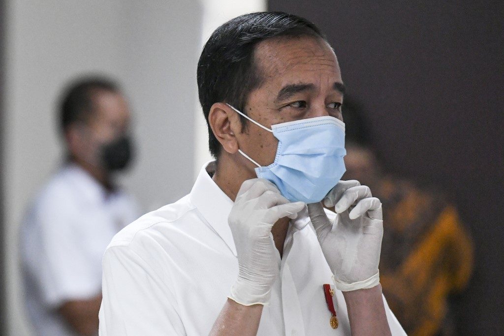 INDONESIA. Indonesia's President Joko Widodo adjusts his face mask while visiting the 2018 Asian Games athlete's village which has been converted into a hospital for COVID-19 coronavirus patients in Jakarta on March 23, 2020. File photo by Hafidz Mubarak A/Pool/AFP 