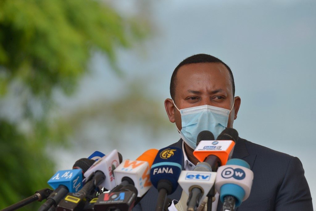 ETHIOPIA. In this file photo, Ethiopia's Prime Minister Abiy speaks before planting a tree during the tree-planting ceremony of his initial project to plant 5 billion trees during this year's rainy season in Hawassa on June 5, 2020, ahead of World Environment Day. File photo by Michael Tewelde/AFP 