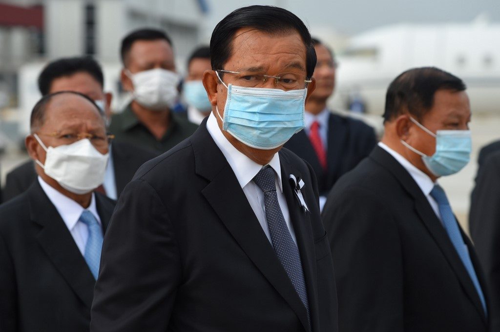 CAMBODIA. Prime Minister Hun Sen (C), President of the National Assembly Heng Samrin (L) and President of the Senate Say Chhum (R) wear face masks, as a preventive measure against the spread of COVID-19, as they wait to receive King Norodom Sihamoni and his mother former queen Monique upon their arrival at Phnom Penh International Airport on May 11, 2020. File photo by Tang Chhin Sothy/AFP 