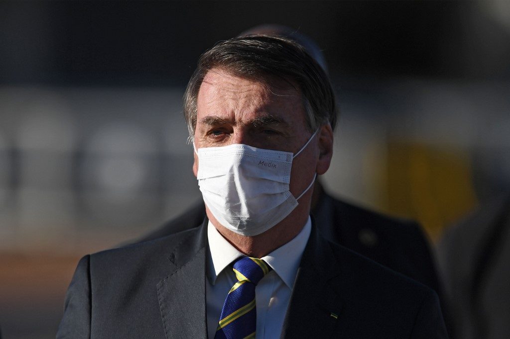 BRAZIL. Brazilian President Jair Bolsonaro wears a face mask as he arrives at the flag-raising ceremony before a ministerial meeting at the Alvorada Palace in Brasilia, on May 12, 2020, amid the new coronavirus pandemic. File photo by Evaristo Sa/AFP 