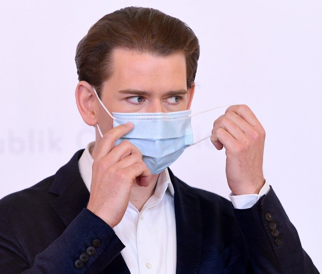 AUSTRIA. Austria's Chancellor Sebastian Kurz takes off his face mask as he arrives to address a press conference on May 8, 2020 at the Chancellery in Vienna, amid the novel coronavirus Covid-19 pandemic. File photo by 
Helmut Fohringer/APA/AFP 