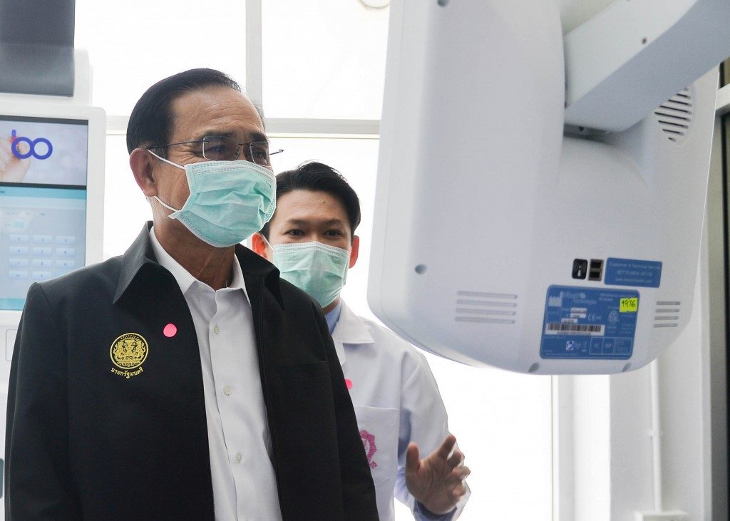THAILAND. This handout photo from the Royal Thai Government taken and released on March 12, 2020 shows Thai Prime Minister Prayut Chan-O-Cha in a face mask visiting Rajavithi Hospital to meet medical staff and inspect patients undergoing treatment from the COVID-19 coronavirus in Bangkok. File photo by Handout/ Royal Thai Government/AFP 
