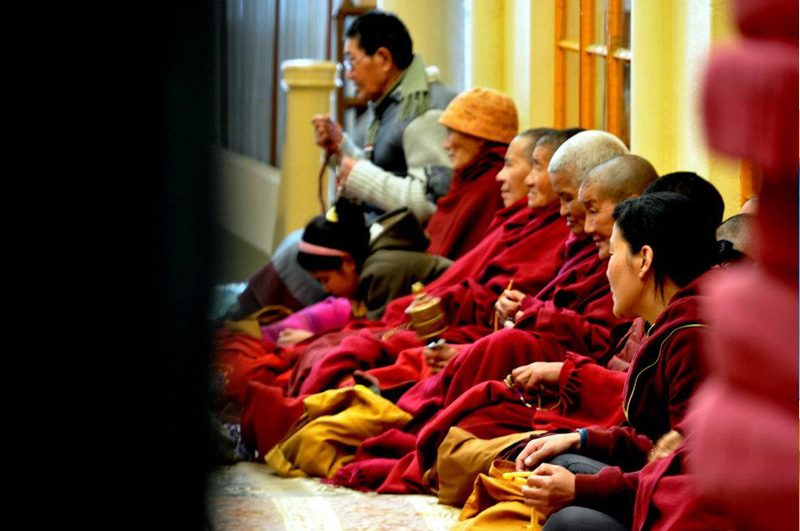 CAPTURED MOMENT. Tibetan followers at the main Monastery of the Dalai Lama