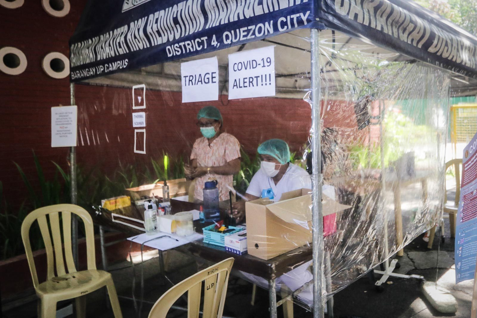 AT RISK. Nurses from the UP Health Service in Diliman, Quezon City, put sheets of plastic as divider between them and patients to protect themselves from COVID-19. Photo by KD Madrilejos/Rappler 