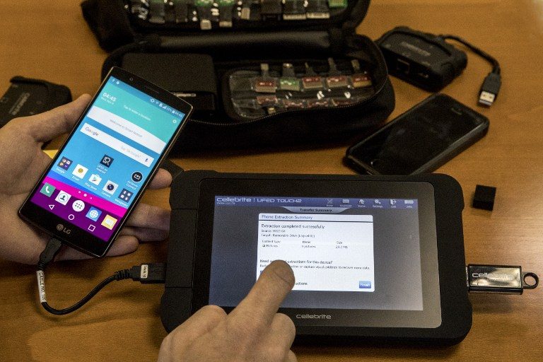 TOOLS OF THE TRADE. An engineer shows devices and explains the technology developed by the Israeli firm Cellebrite's technology on November 9, 2016 in the Israeli city of Petah Tikva. Photo by Jack Guez/AFP 