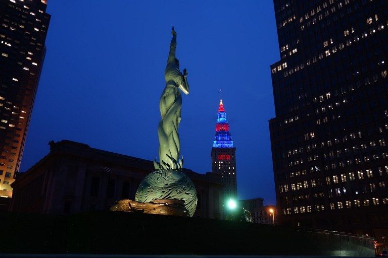 RNC HOST CITY. An illuminated statue on Cleveland's 'Mall' is shown with the Terminal Tower in the background, itself illuminated in the colors of the Cleveland Cavaliers basketball team in Cleveland, Ohio on April 6, 2016.
Cleveland will host the Republican National Convention from July 18-21, 2016. William Edwards/AFP 