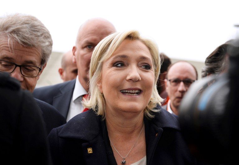 Head of the far-right party FN and presidential candidate Marine Le Pen (C) smiles as she arrives to visit the Salon des Entrepreneurs (Entrepreneurship fair) in Paris on February 1, 2017. Eric Piermont/AFP 