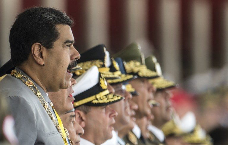 MILITARY BACKING. Venezelan President Nicolas Maduro  and members of the military high command seen during a military parade in Caracas on February 1, 2017. Photo by Juan Barretto/AFP 
