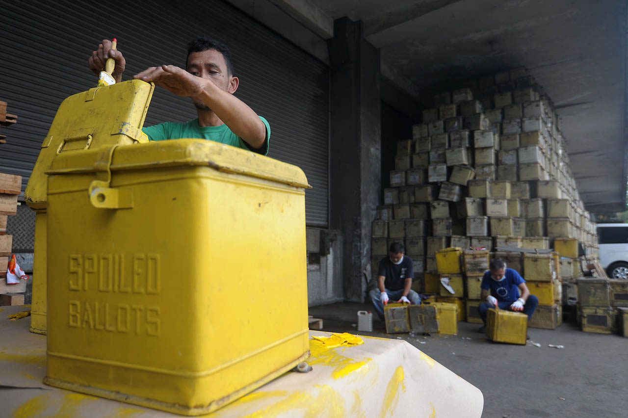 BACK TO BASICS. Workers repaint old ballot boxes inside the COMELEC warehouse in Port Area, Manila on April 12, 2018 in prepration for the May 14 polls. Photo by Ben Nabong/Rappler 