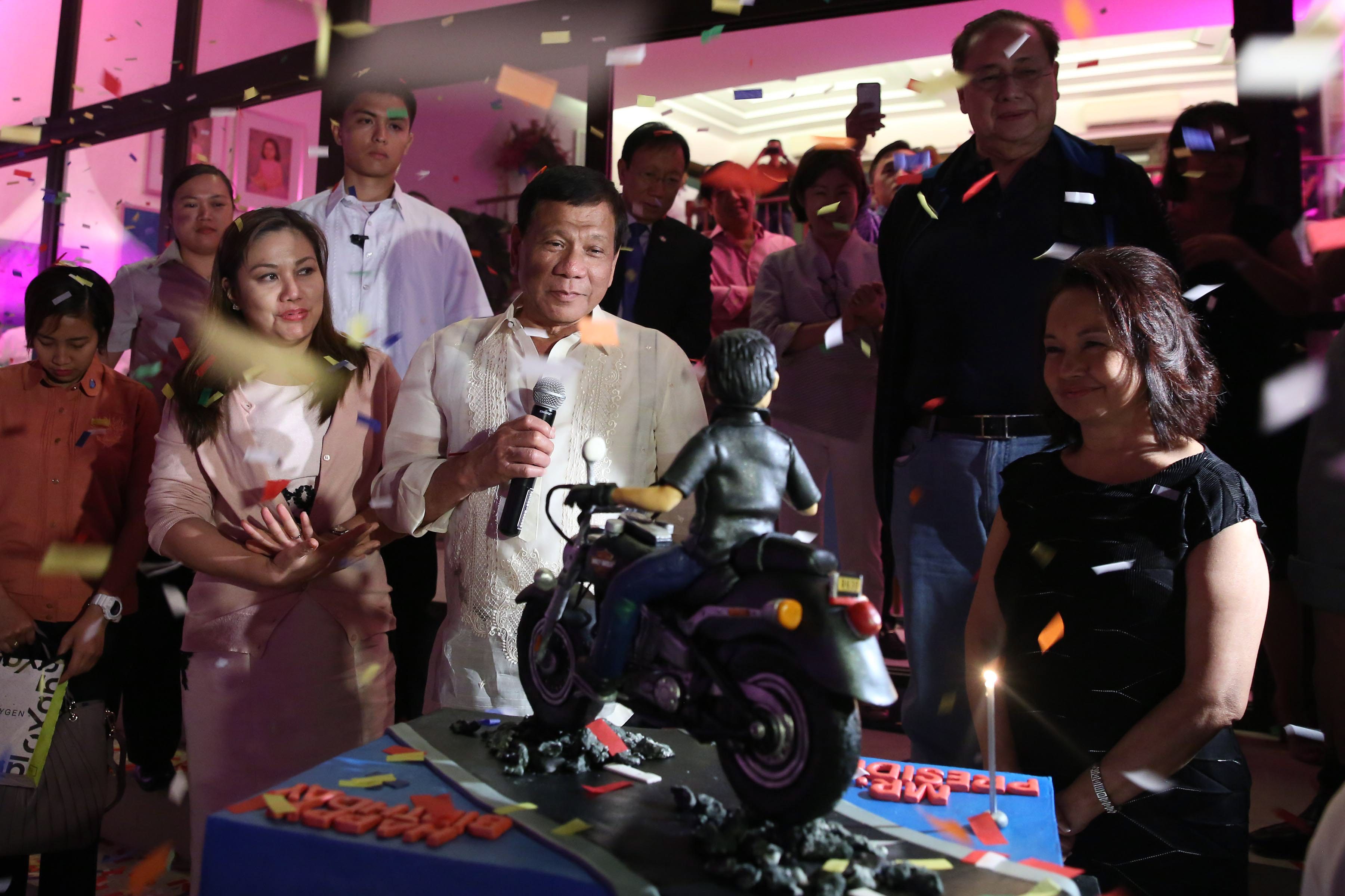 SURPRISE CAKE. President Rodrigo Duterte is presented a birthday cake with a figurine of him riding a motorcycle. Malacañang photo 
