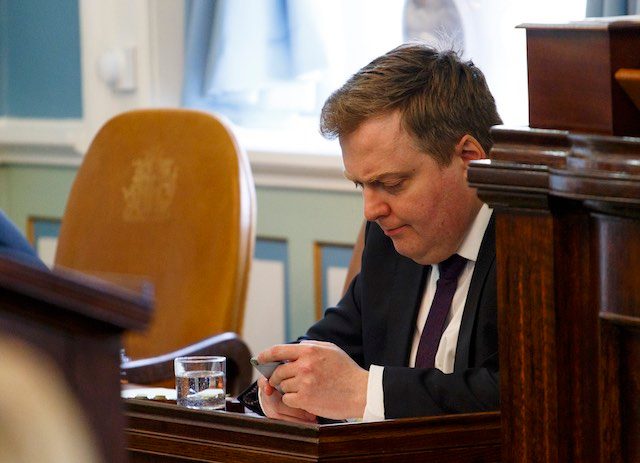 UNDER FIRE. Iceland's Prime Minister Sigmundur David Gunnlaugsson looks at his phone at the Icelandic Parliament in Reykjavik, Iceland, April 4, 2016. Stringer/EPA 