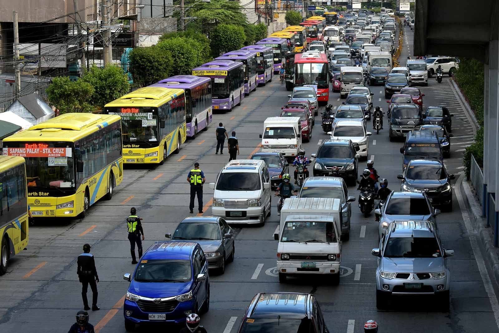NEW BUS SYSTEM. Buses queue at the southbound lane of EDSA near the MRT North Avenue station as rush hour traffic builds up during the first day of the General Community Quarantine (GCQ) in NCR o June 1, 2020. Photo by Angie de Silva/Rappler 