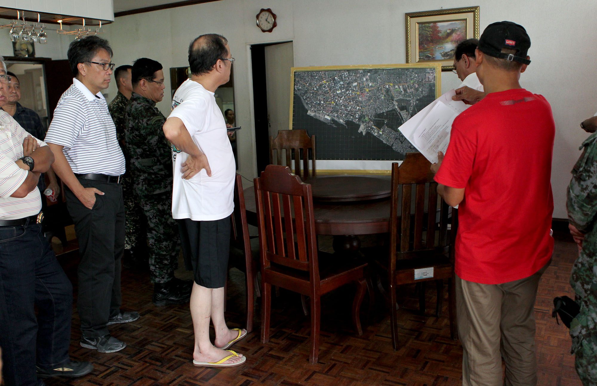 ZAMBOANGA SIEGE. A rare photo of the President in shorts and rubber slippers. They are briefed on the latest situation in the Zamboanga siege at the Edwin Andrews Air Base on September 15, 2013. He spends 11 days in the camp to personally oversee operations.   