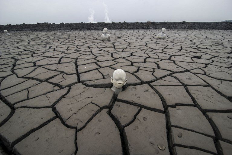 VOLCANO TOURISM. Statues stand semi-submerged in mud – a symbol of the human toll of the 2006 disaster – at the mud volcano incident area in Sidoarjo, Java, Indonesia on May 29, 2017. Photo by Juni Kriswanto/AFP   