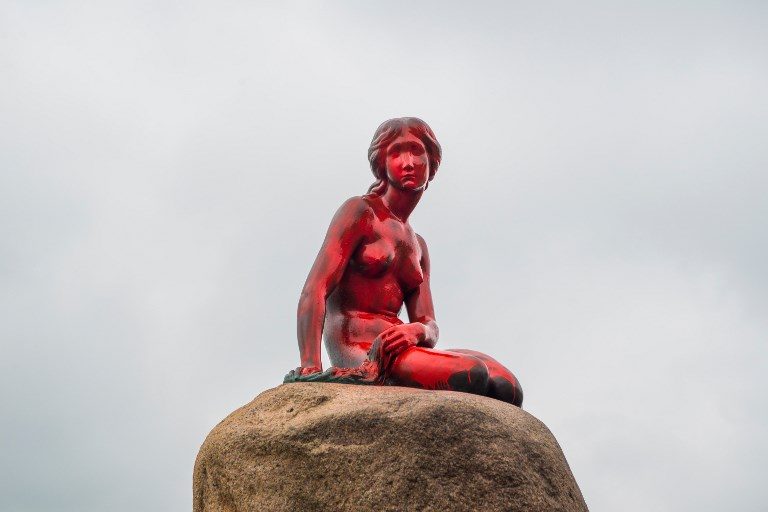 VANDALIZED. Copenhagen's world famous statue of The Little Mermaid is pictured after it has vandalized and painted red on May 30, 2017. Photo by Ida Marie Odgaard/AFP   