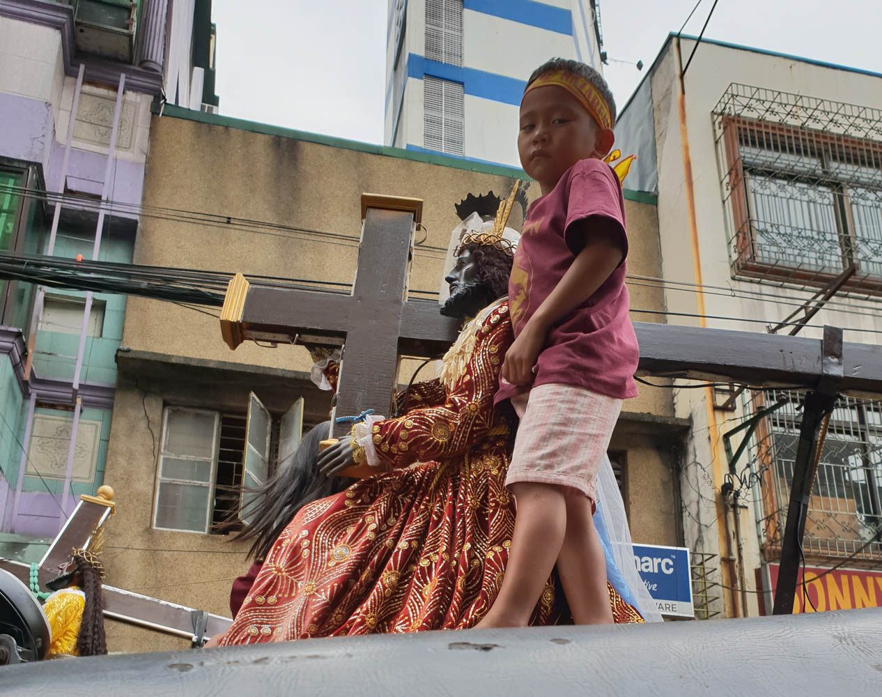 YOUNG DEVOTEE. Angelo Uchi guards his family's replica of the Black Nazarene atop his father's tricycle during the replica procession in Quiapo, Manila, on January 7, 2020. Photo by JC Gotinga/Rappler 