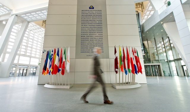 A man walks past a board displaying the words 'European Central Bank' in 24 languages at the European Central Bank (EZB) in Frankfurt/Main, Germany, 20 February 2015. Christoph Schmidt/EPA 