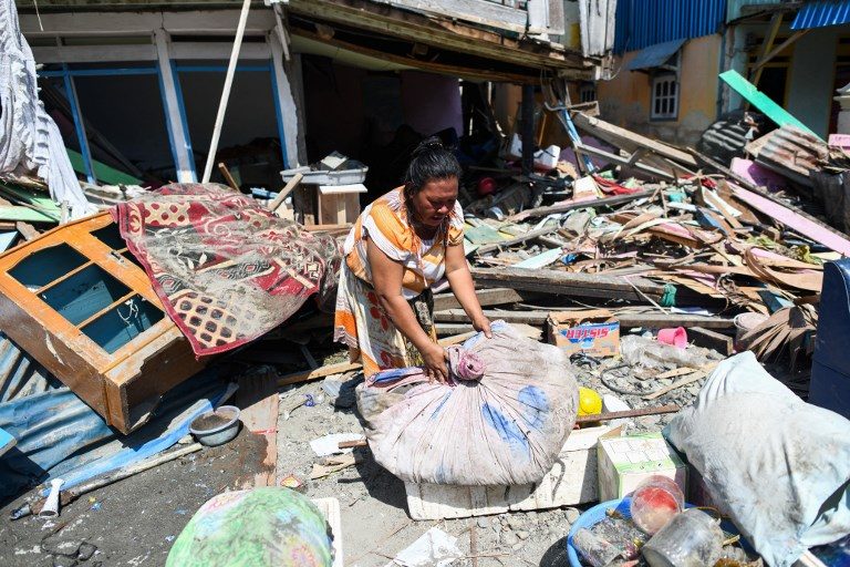 TSUNAMI IN INDONESIA. A quake survivor salvages items from the debris of a house in Wani in Indonesia's Central Sulawesi on October 3, 2018, after an earthquake and tsunami hit the area on September 28. Photo by Jewel Samad/AFP
 