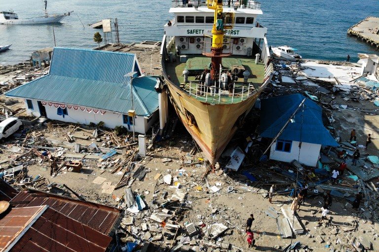 DISPLACED. A photograph taken on October 3, 2018, shows a passenger ferry that was washed ashore into buildings in Wani, Indonesia's Central Sulawesi, after an earthquake and tsunami hit the area on September 28. Photo by Jewel Samad/AFP  