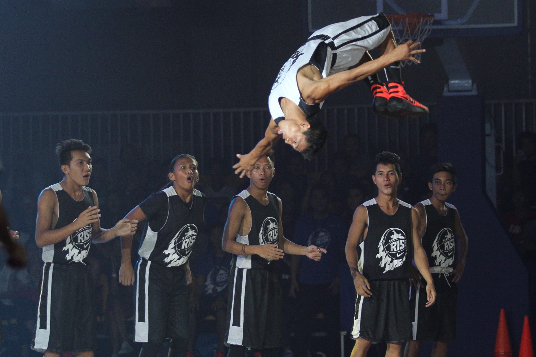 DRAMATIC ENTRANCE. One player shows off a perfect back flip as his name is called on the court. Photo by Czeasar Dancel/Rappler  