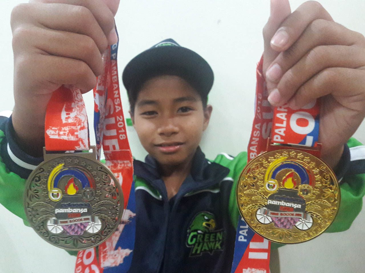 GOLD-SILVER. Jan Clifford Labog of Cagayan Valley displays his gold and silver medals in the individual and team chess blitz elementary boys division. Photos by Mau Victa/Rappler  