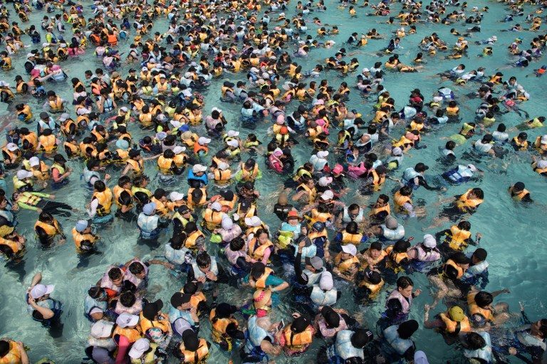 WATER FUN. People gather in a wave pool at the Caribbean Bay water park in Yongin, outside Seoul on August 6, 2018. Photo by Ed Jones/AFP  