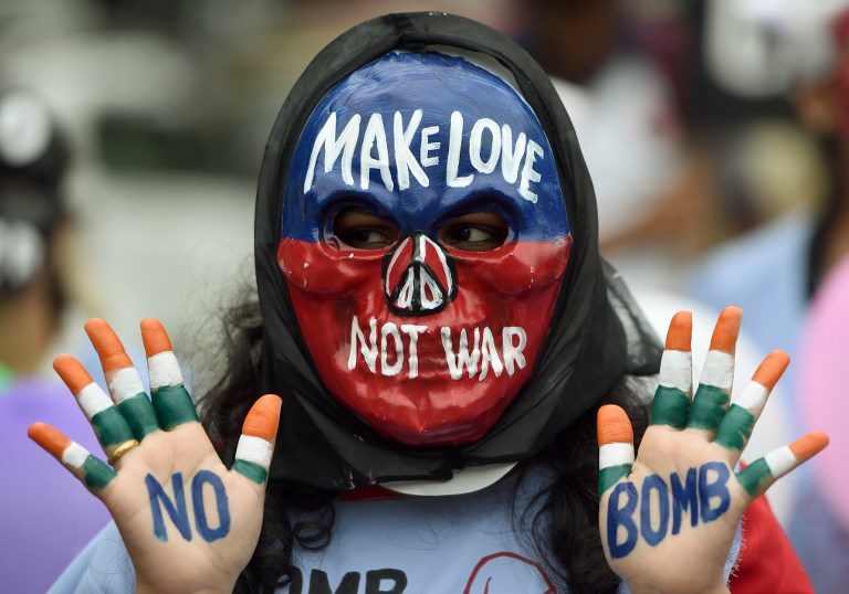 NO TO WAR. An Indian student wearing a mask poses with her hands painted with a slogans for peace during a rally to mark Hiroshima Day in Mumbai on August 6, 2018. Photo by Punit Paranjpe/AFP  