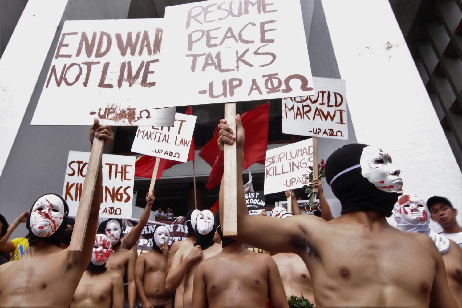 NAKED TRUTH. Alpha Phi Omega fraternity members of the University of the Philippines stage their annual Oblation Run on December 1, 2017, calling on the government to fulfill its mandate to serve the people by protecting their welfare and interests. Photo by Darren Langit/Rappler   