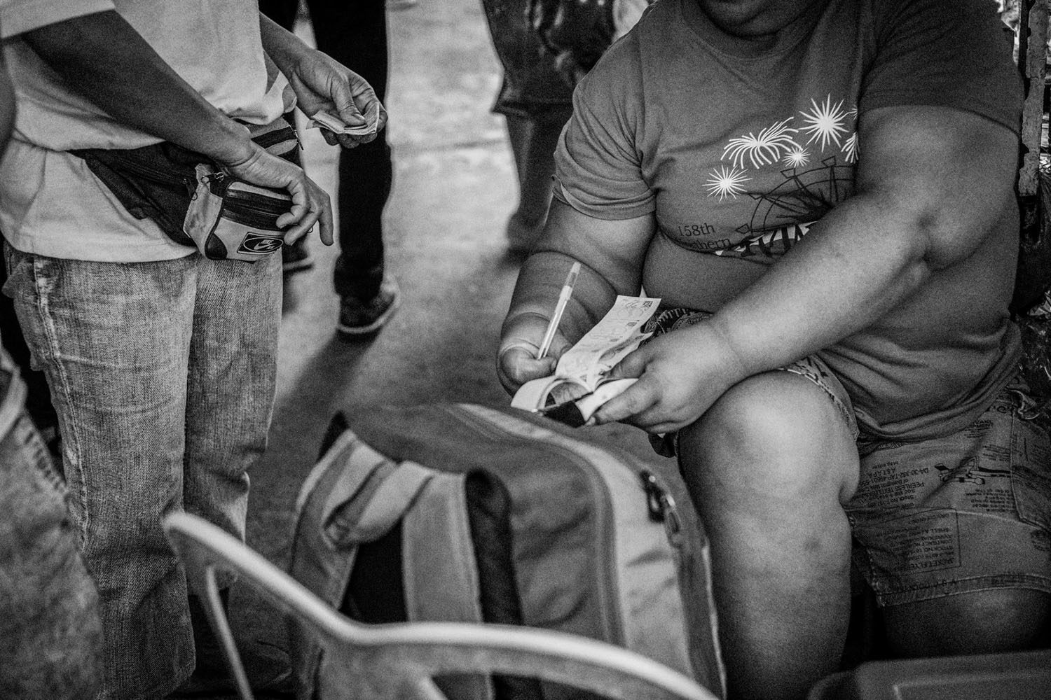 JUETENG COLLECTOR. Jueteng, an illegal numbers game, is played in many parts of the Philippines and has been a source of additional income for rural families. Photo by Rick Rocamora