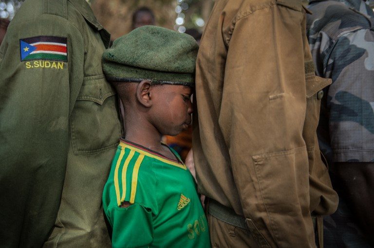 CHILD SOLDIER. Newly released child soldiers wait in a line for their registration during the release ceremony in Yambio, South Sudan on February 7, 2018. Photo by Stefanie Glinski/AFP  