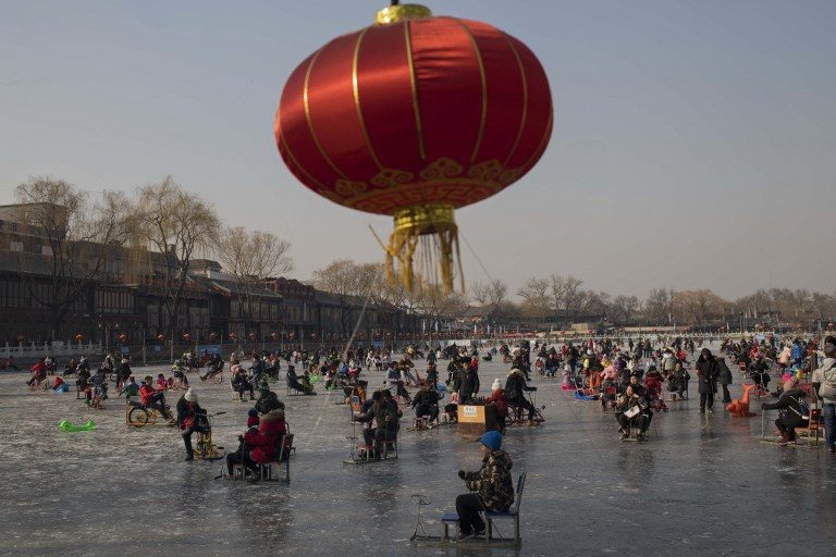 LUNAR NEW YEAR PREPS. People enjoy riding on the ice of the frozen Hou Hai lake in Beijing on February 6, 2018 ahead of the Chinese Lunar New Year. Photo by Nicolas Asfouri/AFP  