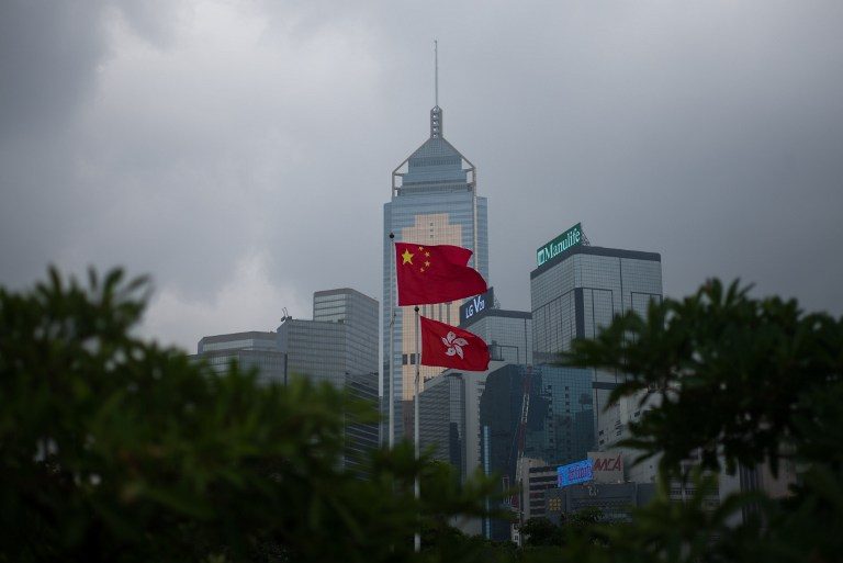 Divided Hong Kong gets new leader as China looks on